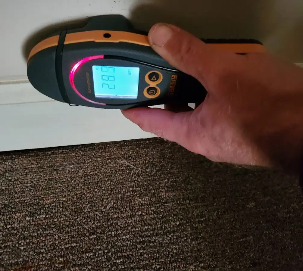 Moisture detection at baseboard during Storm Damage Restoration in Burrillville